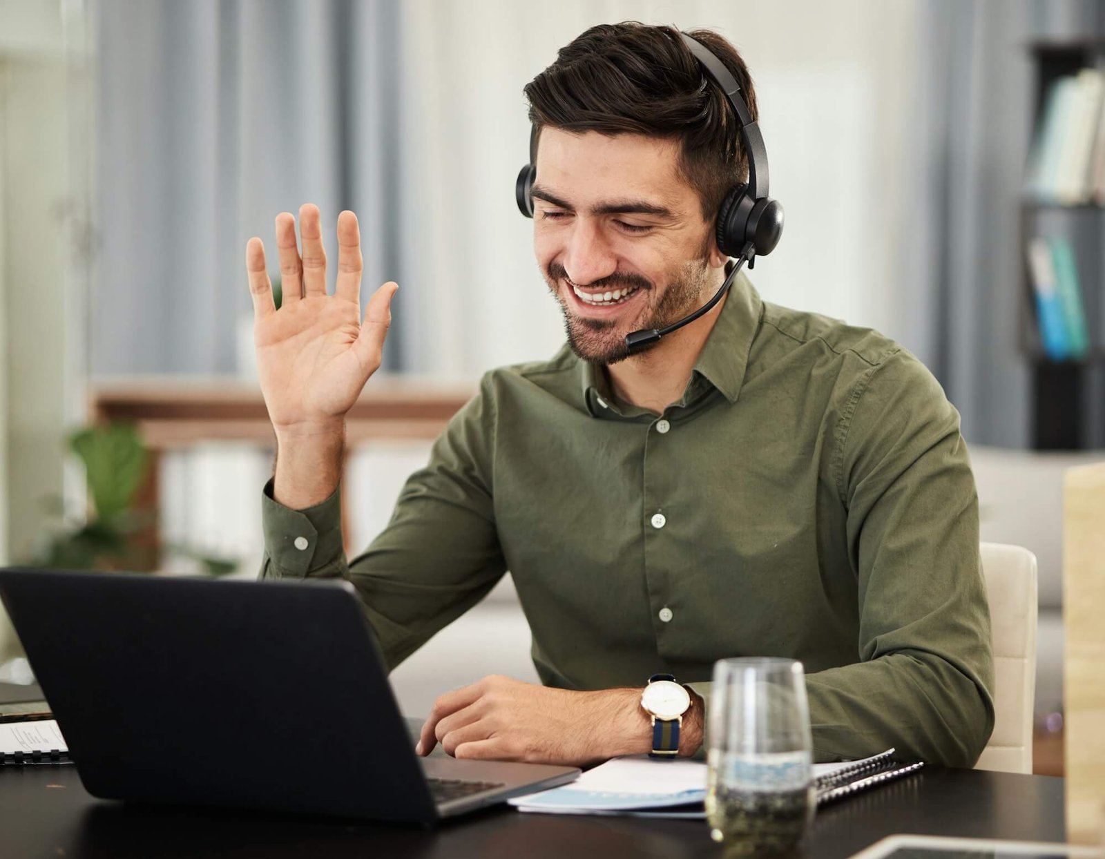 man-remote-work-and-virtual-assistant-with-headphones-at-laptop-for-video-call-voip-communication-1.jpg